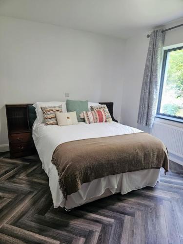 a bedroom with a bed and a window at Finner-House in Bundoran