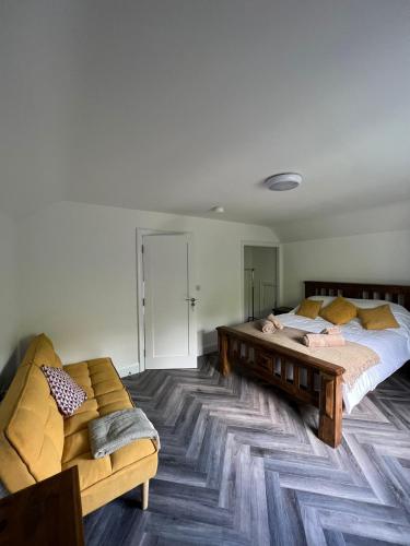 a bedroom with two beds and a couch in it at Finner-House in Bundoran