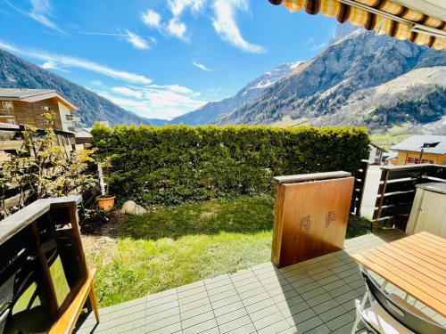a balcony with a view of a mountain at Sunny-Nest, Garden Apartment in Leukerbad
