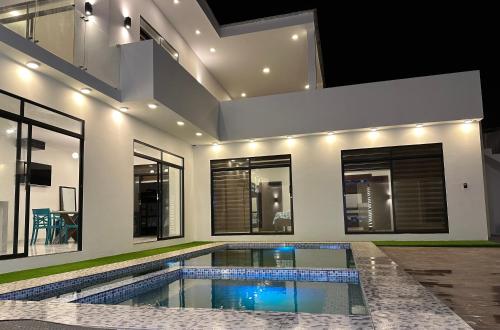 a swimming pool in the middle of a house at Villasrock2022 in San Clemente
