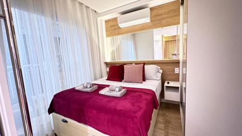 a bedroom with a bed with two towels on it at 1811 - Rentaqui Summint Premium Pinheiros in Sao Paulo