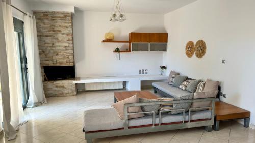 a living room with a couch and a table at Penelope's House in Afantou