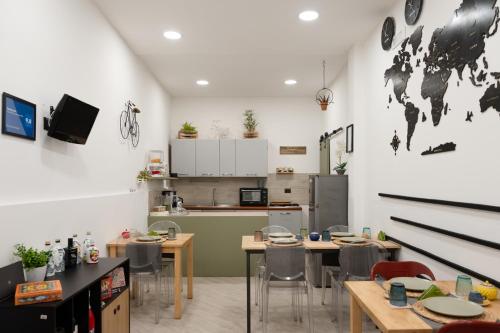 a kitchen with tables and chairs in a room at Principe Giardinelli in Piazza Armerina