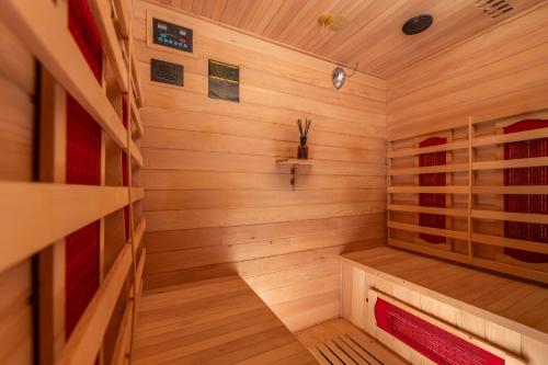 a wooden sauna with a bench in the middle at Vila Grad Bled - Sauna & Hot tub in Bled