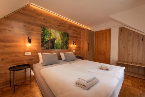 a bedroom with a large bed with towels on it at Vila Grad Bled - Sauna & Hot tub in Bled