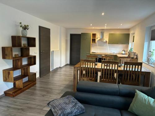 a living room with a couch and a kitchen at Ferienwohnung Papststeinblick in Kurort Gohrisch