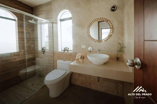 La salle de bains est pourvue de toilettes, d'un lavabo et d'un miroir. dans l'établissement Casa de campo Alto del Prado, à Huánuco