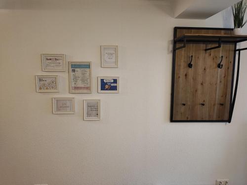 a wall with a wooden door and pictures on it at FeWo Planer Altstadtwohnung mit Terrasse & Parkplatz in Memmingen