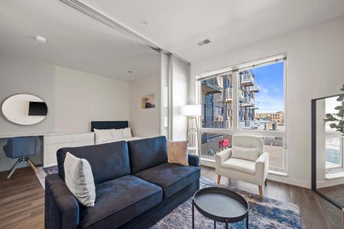 a living room with a couch and a chair at Downtown View Near Lake Michigan Plaza Black in Milwaukee
