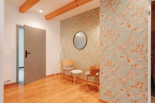 a room with a table and chairs and a mirror at Hviezdoslavova Apartments, Trnava Centre, Parking available in Trnava