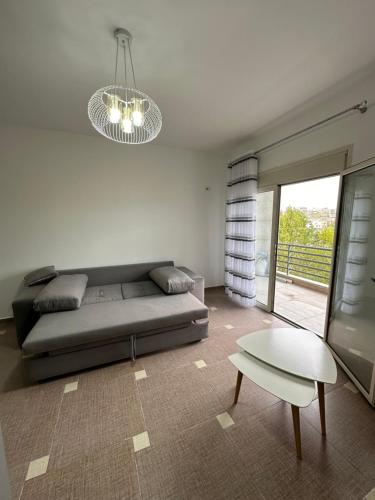 a living room with a couch and a table at Cozy and Comfortable Apartment 2 in Durrës