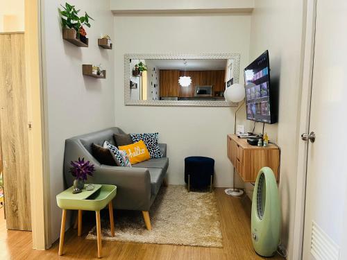 a small living room with a couch and a table at The Elevated Abode - ComfyCosy 1-br at The Loop in Cagayan de Oro