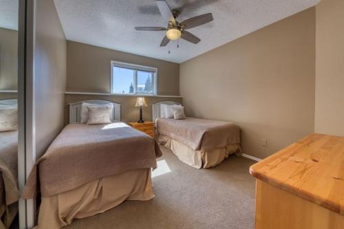 a bedroom with two beds and a ceiling fan at Marble Canyon in Fairmont Hot Springs