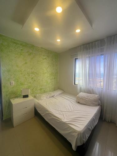 a small bedroom with a bed and a window at Apartamento vista al mar in Cartagena de Indias