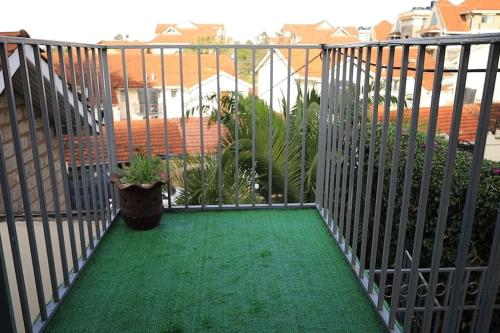 a balcony with a green floor and a fence at U4RIC Villa-3bed house in Kileleshwa gated community in Nairobi