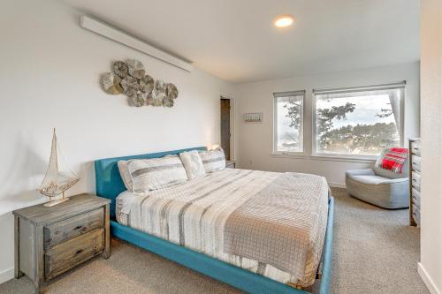 a bedroom with a blue bed and a chair at Depoe Bay Townhome with Deck and Stunning Ocean Views! in Depoe Bay