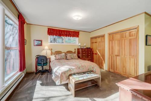 a bedroom with a bed and a desk and a chair at Spacious Classic Cabin Retreat- near Lassen in Mill Creek