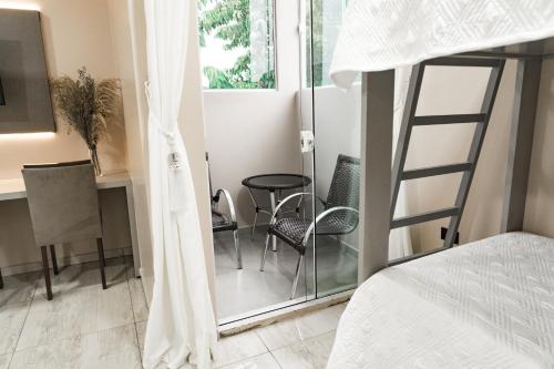 a bedroom with a bed and a table and chairs at MD Recanto Iguaçu in Foz do Iguaçu