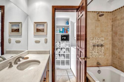 a bathroom with a tub and a sink at Newly remodeled unit in Flamingo with sweeping ocean views from big terrace in Playa Flamingo