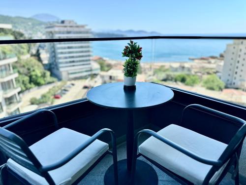 a table and two chairs on a balcony with a view at Hotel Del Medio in Sutomore
