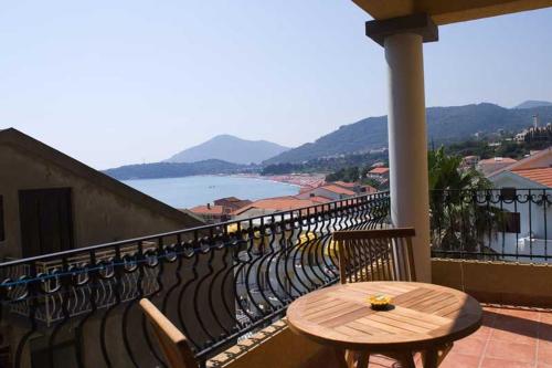 a wooden table sitting on top of a balcony at Garni Hotel Meduza in Rafailovici