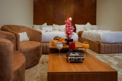 a living room with a table with drinks on it at The Muse Pyramids INN in Cairo