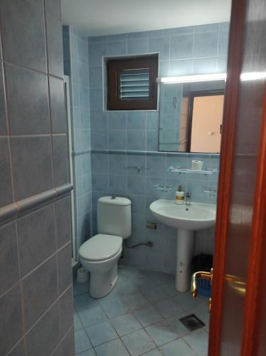 a bathroom with a toilet and a sink at Garni Hotel Meduza in Rafailovici