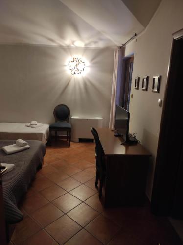 a room with two beds and a desk with a computer at Garni Hotel Meduza in Rafailovici