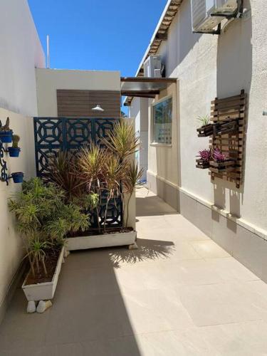 einen Flur mit Topfpflanzen an der Seite eines Gebäudes in der Unterkunft Casinha da Paz in Aracaju