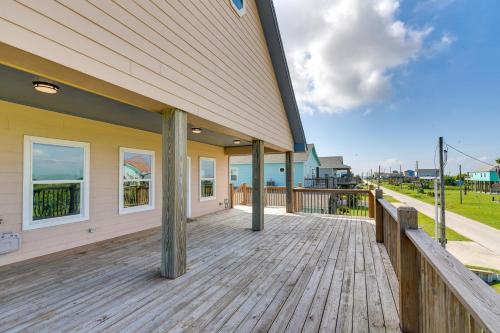 a large wooden deck on the side of a house at Walk to Crystal Beach Family Home with Deck in Crystal Beach