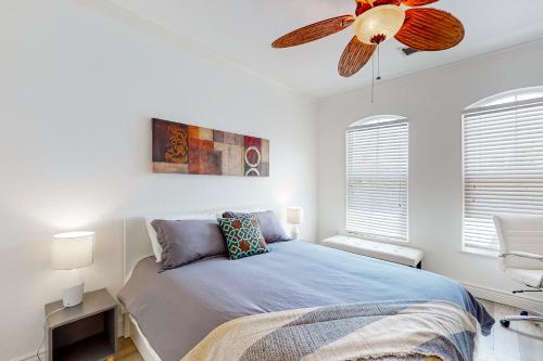 a bedroom with a bed and a ceiling fan at Clearwater Captivation in Clearwater