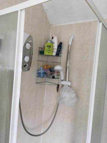 a bathroom with a shower with a shower head at SOUTHEY HALL ROAD in Sheffield