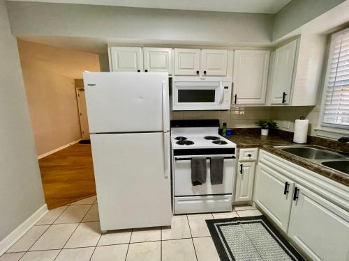 a kitchen with a white refrigerator and a stove at Cathedral 1-Walking Distance to UNMC in Omaha