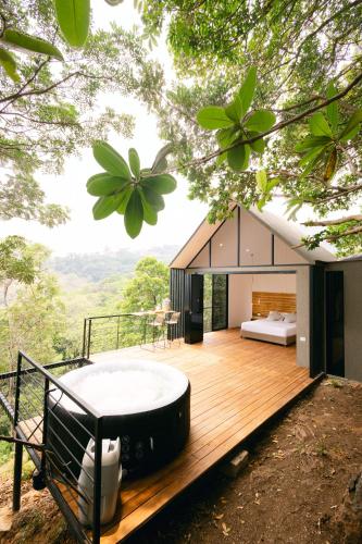 a house with a bath tub on a wooden deck at Glamping MontdeLuxe in Yopal