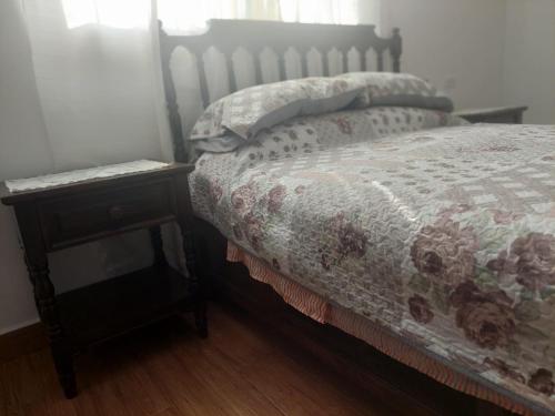 a bedroom with a bed and a nightstand with a bed sidx sidx at Posada Santa Elena in Santa María Atlihuetzián