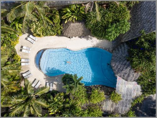 an overhead view of a swimming pool in a resort at Sanctuary Rarotonga on the Beach (Adults Only) in Rarotonga