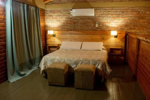 a bedroom with a bed with two pillows at Cabañas Abigail in Nono