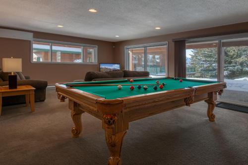 a living room with a pool table in it at Marble Canyon in Fairmont Hot Springs