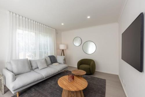 a living room with a couch and a table at Elegant 2-bedroom House in Prahran w Parking! in Melbourne