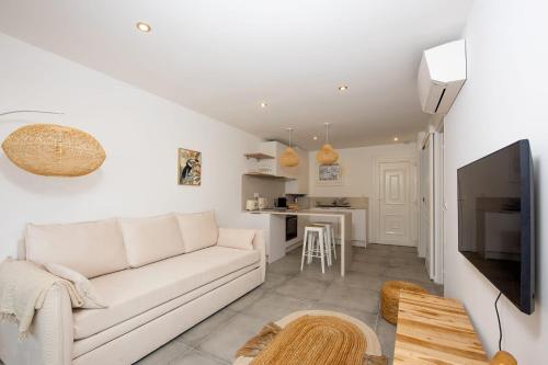 un salon avec un canapé blanc et une cuisine dans l'établissement Appartement Dollia - Welkeys, à Cannes
