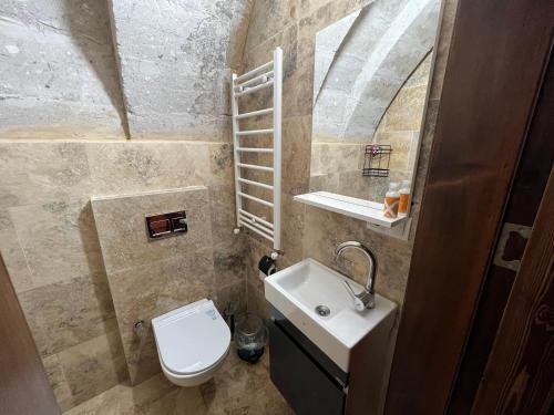 a small bathroom with a toilet and a sink at Cappadocıa Tuğhan Stone House in Nevşehir