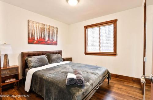 a bedroom with a bed and a window at Kids under 4 free, Jacuzzi, Sauna, Pool, Lake, Gym in Albrightsville