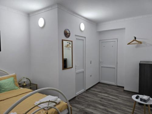 a bedroom with a bed and a mirror on the wall at ELDI House in Făgăraş