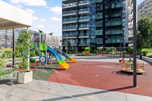 a playground in a city with a slide at ONE Luxury Apartments in Bucharest
