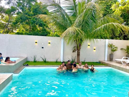 a group of people in a swimming pool at HOSTAL AMBORO in Buena Vista