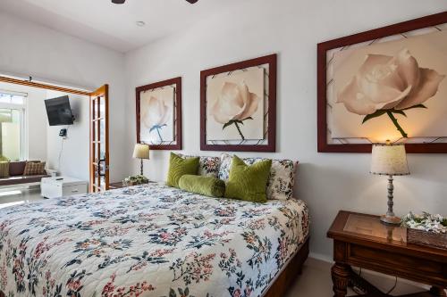 a bedroom with a bed and two paintings on the wall at Villa Olivo 45 - Playa Arcangel in Rosarito