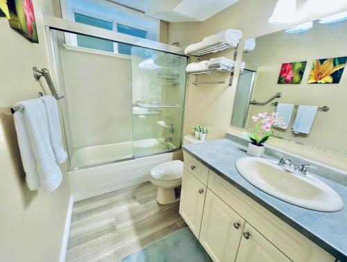 a bathroom with a sink and a shower and a toilet at Marine Melody in Nanaimo