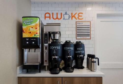 a coffee machine on a shelf in front of a wall at Sonesta ES Suites San Diego - Sorrento Mesa in Sorrento