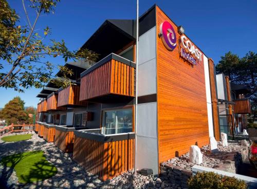 a building with a sign on the side of it at Coast Metro Vancouver Hotel in Burnaby