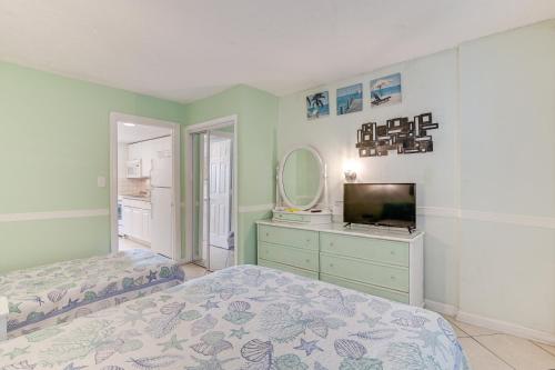 A bed or beds in a room at Steps to Ocean Myrtle Beach Condo with Perks!